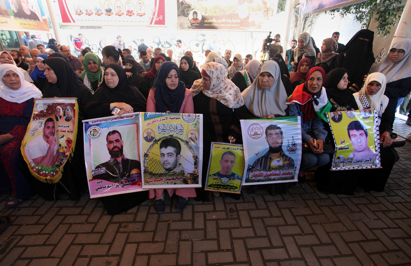 Palestinians demonstrate in solidarity with Palestinian prisoners held in Israeli jails, in front of the Red Cross office in Gaza City on 10 June.  Mahmoud Ajjour APA images